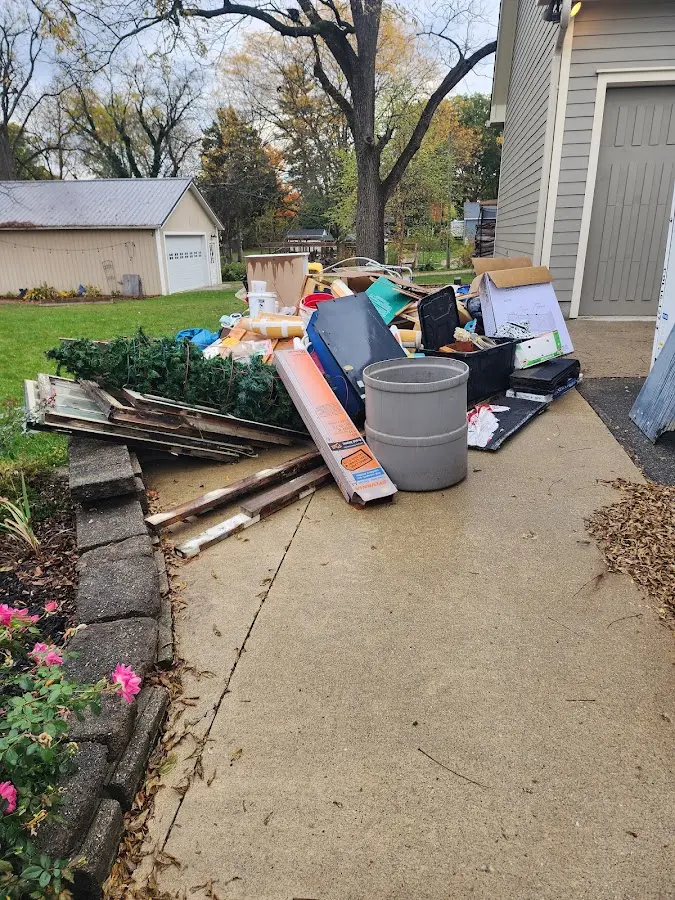 Dumpster being loaded with debris for 10 Yard Dumpster Rental in Lake Barcroft